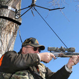 Man in Tree Stand With Harness on, aiming.